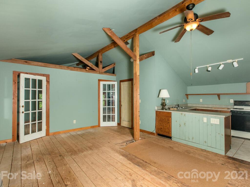 723 North Highland Road, Unit 9 10 11 Mill Spring, NC 28756 - Photo 15 of 46 a bedroom with a bed and a chandelier
