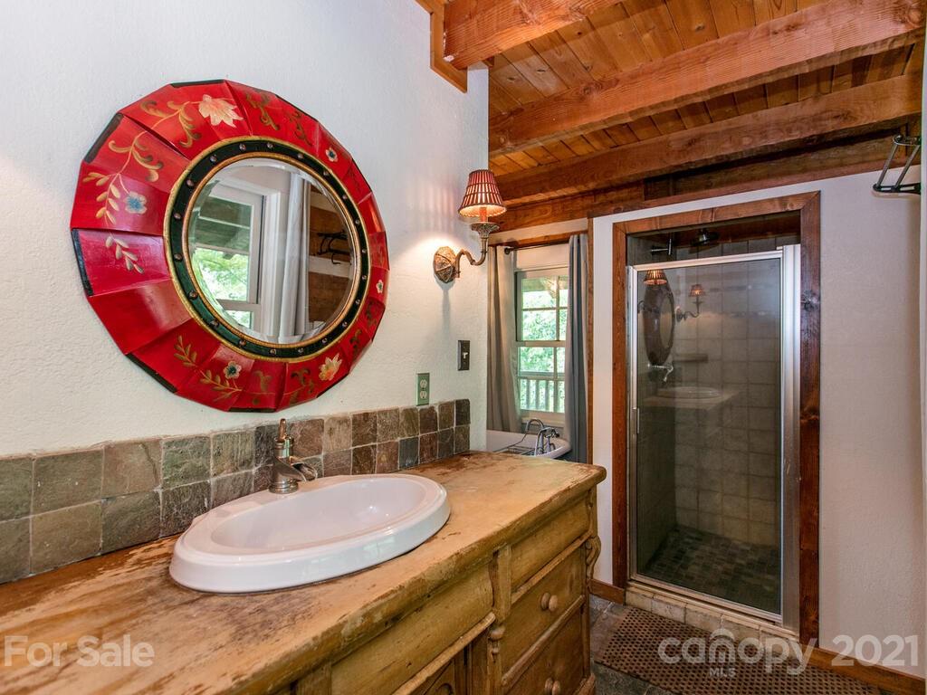 723 North Highland Road, Unit 9 10 11 Mill Spring, NC 28756 - Photo 17 of 46 a bathroom with a sink and a mirror
