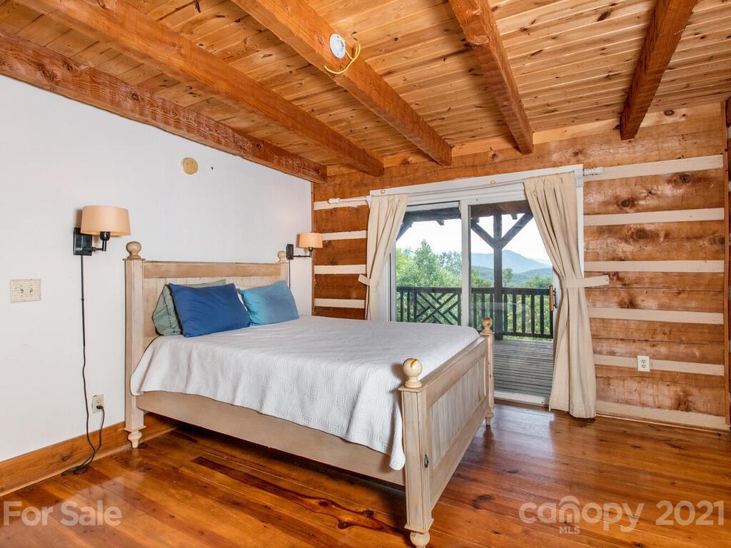 723 North Highland Road, Unit 9 10 11 Mill Spring, NC 28756 - Photo 21 of 46 a bedroom with a bed and a large window