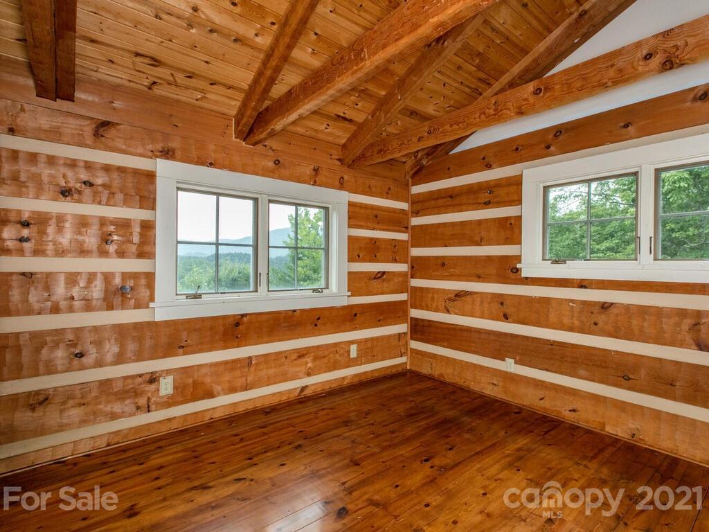 723 North Highland Road, Unit 9 10 11 Mill Spring, NC 28756 - Photo 22 of 46 a view of room with wooden floor and windows