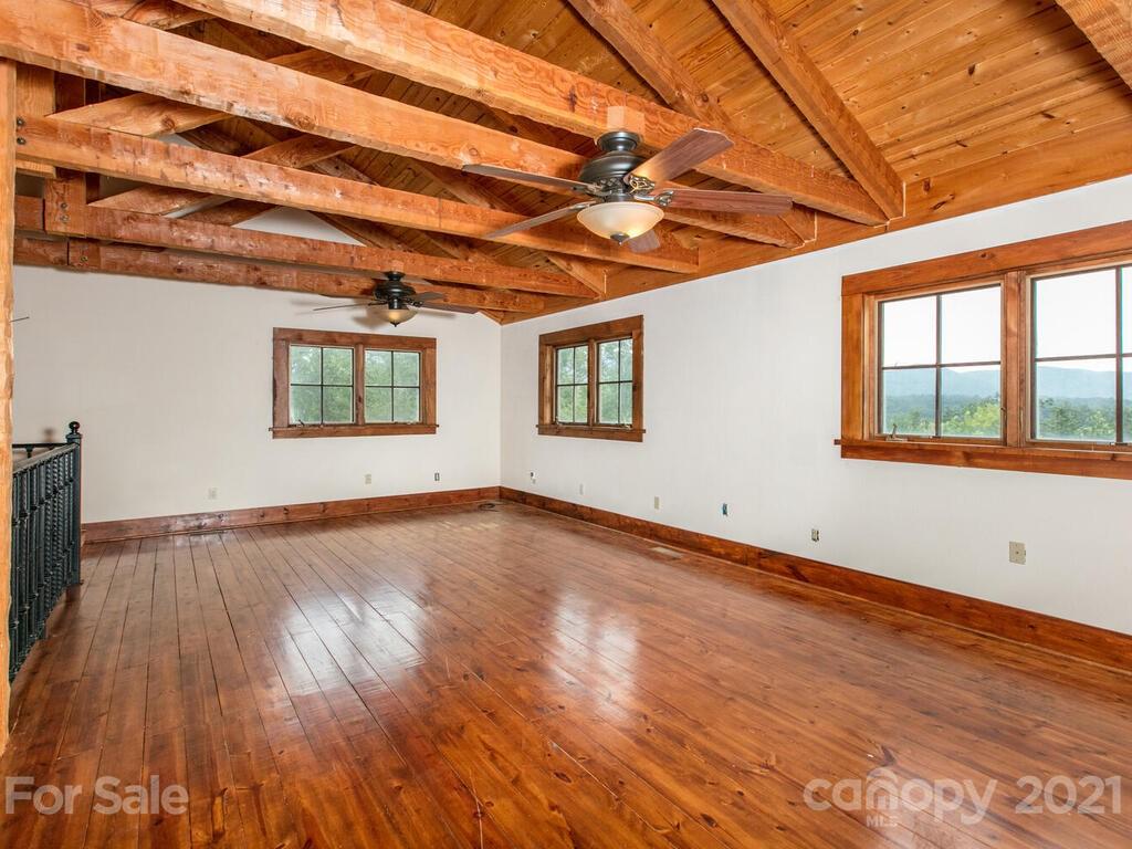 723 North Highland Road, Unit 9 10 11 Mill Spring, NC 28756 - Photo 4 of 46 a view of empty room with wooden floor and fan