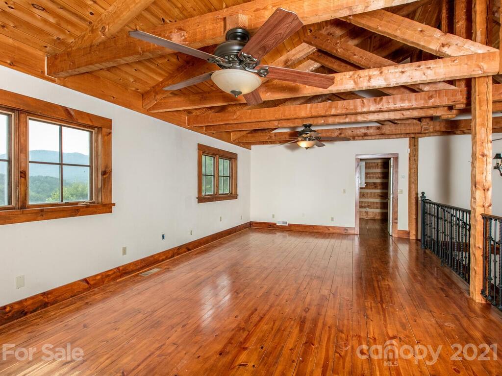 723 North Highland Road, Unit 9 10 11 Mill Spring, NC 28756 - Photo 36 of 46 a view of a room with wooden floors and stairs