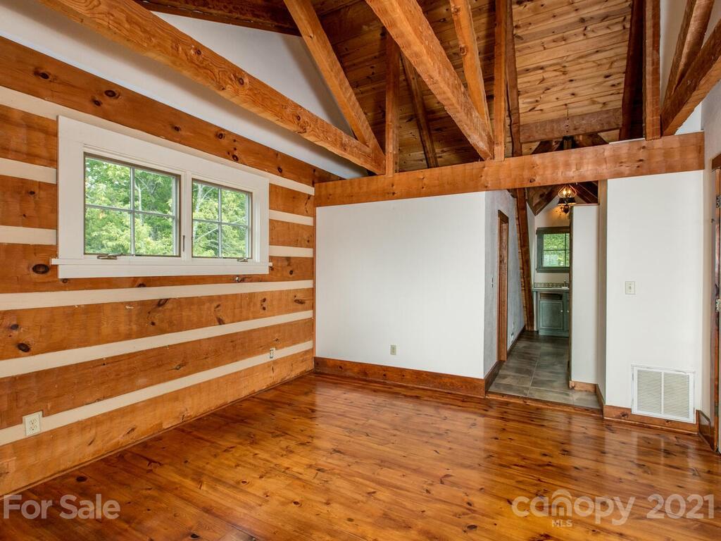 723 North Highland Road, Unit 9 10 11 Mill Spring, NC 28756 - Photo 40 of 46 a view of an empty room with wooden floor and a window