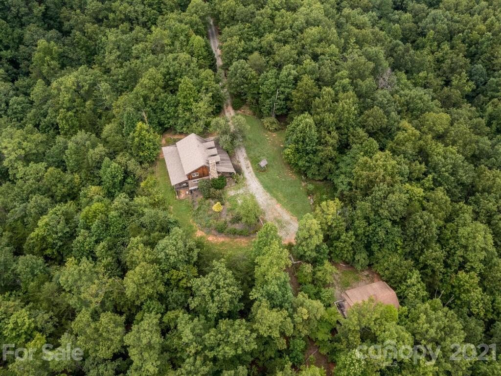 723 North Highland Road, Unit 9 10 11 Mill Spring, NC 28756 - Photo 43 of 46 an aerial view of residential house with outdoor space and trees all around