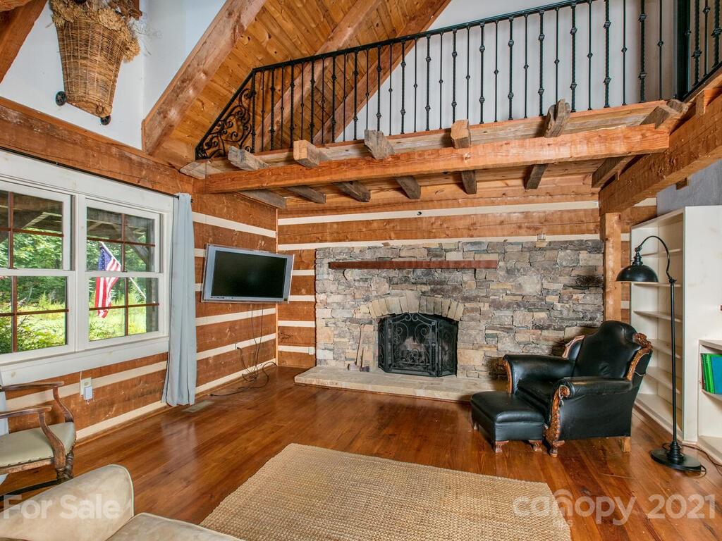 723 North Highland Road, Unit 9 10 11 Mill Spring, NC 28756 - Photo 6 of 46 a living room with furniture a fireplace and a floor to ceiling window