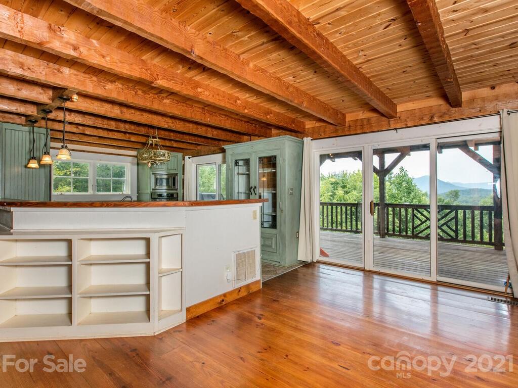 723 North Highland Road, Unit 9 10 11 Mill Spring, NC 28756 - Photo 8 of 46 a view of a room with wooden walls and a large window