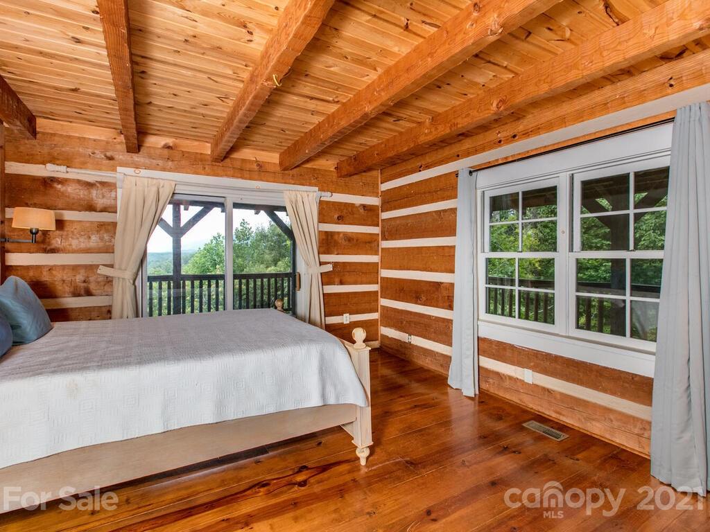 723 North Highland Road, Unit 9 10 11 Mill Spring, NC 28756 - Photo 9 of 46 a bedroom with a bed and a large window