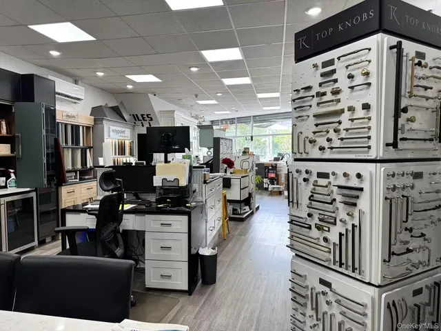 a kitchen with stainless steel appliances kitchen island granite countertop a stove and a refrigerator