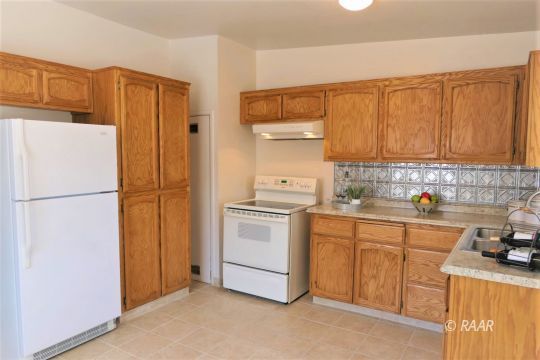 744 West Reeves Avenue Ridgecrest, CA 93555 - Photo 7 of 26 a kitchen with stainless steel appliances granite countertop a refrigerator a stove a sink and a white cabinets