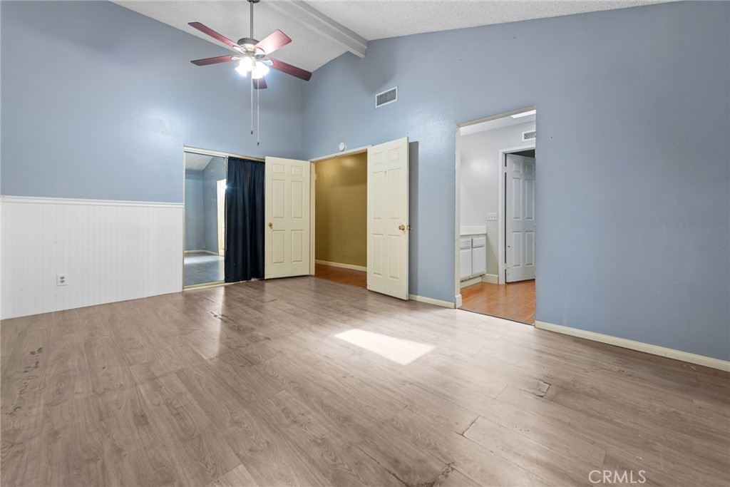 3208 Gibraltar Dr. Riverside, CA 92506 - Photo 17 of 37 a view of an empty room with wooden floor and a ceiling fan
