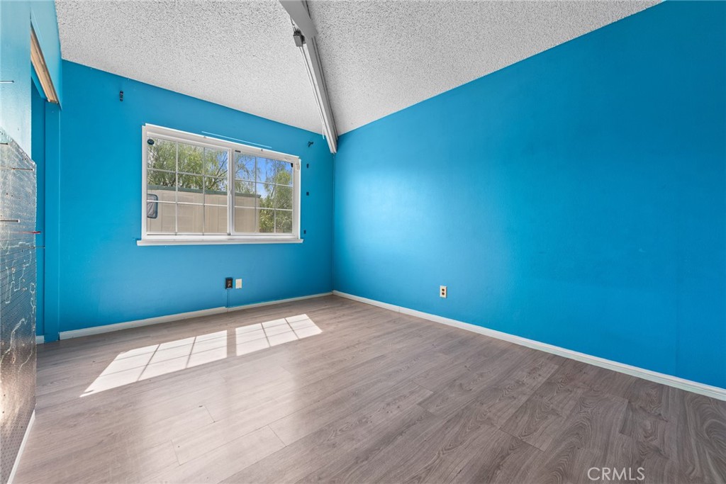 3208 Gibraltar Dr. Riverside, CA 92506 - Photo 26 of 37 an empty room with wooden floor and windows