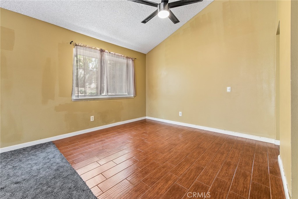 3208 Gibraltar Dr. Riverside, CA 92506 - Photo 8 of 37 a view of an empty room with wooden floor and a window
