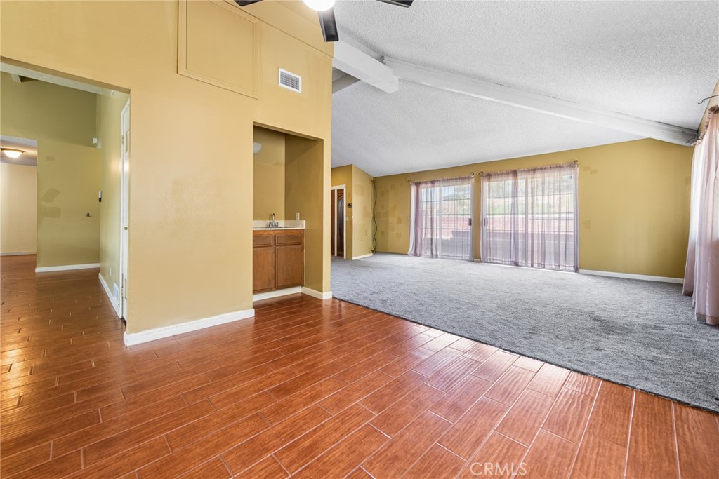 3208 Gibraltar Dr. Riverside, CA 92506 - Photo 9 of 37 a view of an empty room with wooden floor and a window