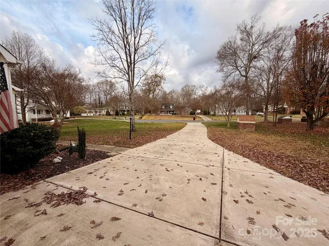 a view of a yard with wooden fence