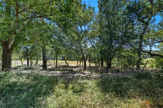 a view of a yard with swimming pool