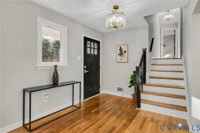 a view of entryway and hall with wooden floor