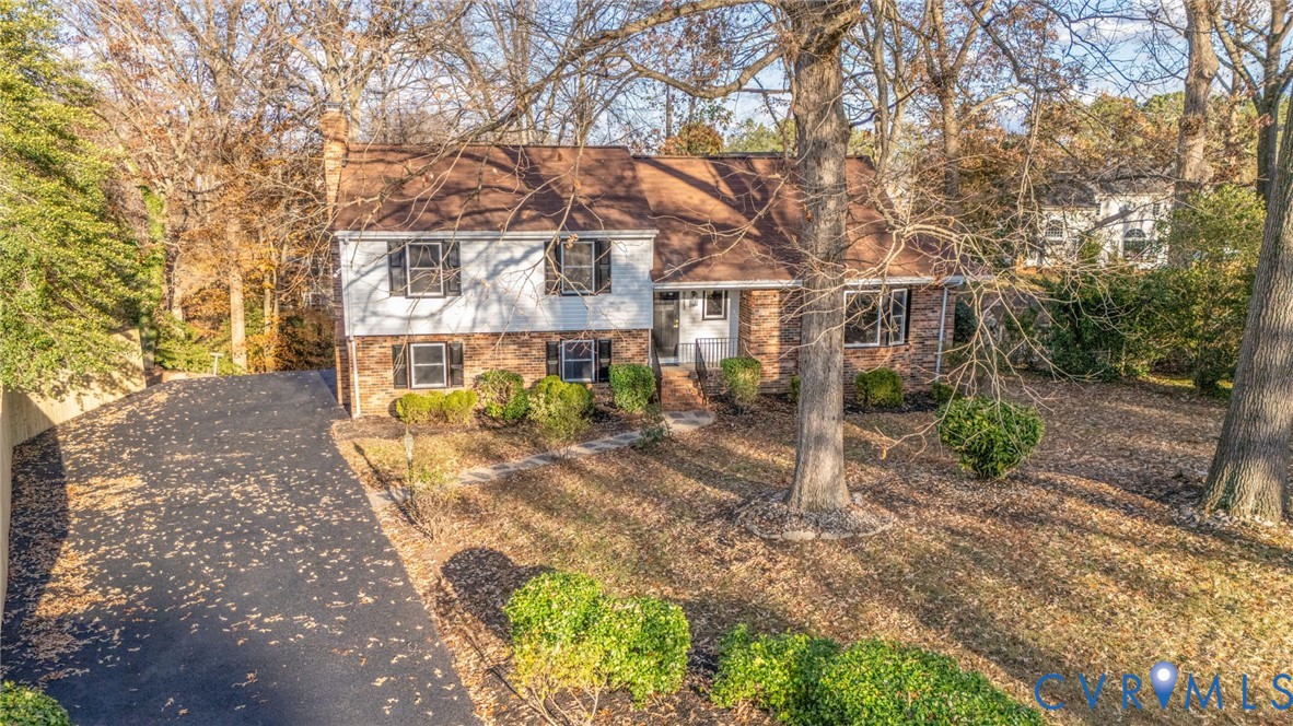 8513 Spring Hollow Drive Richmond, VA 23227 - Photo 2 of 49 a view of a patio with table and chairs under an umbrella