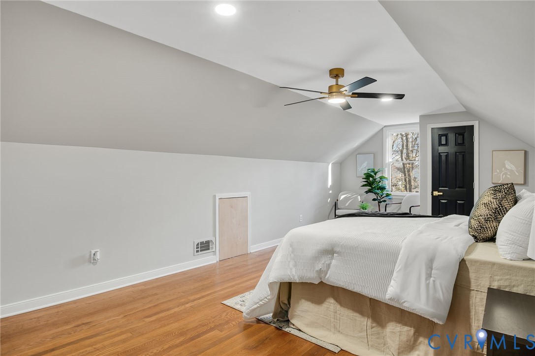 8513 Spring Hollow Drive Richmond, VA 23227 - Photo 30 of 49 a bedroom with a bed chandelier and a potted plant