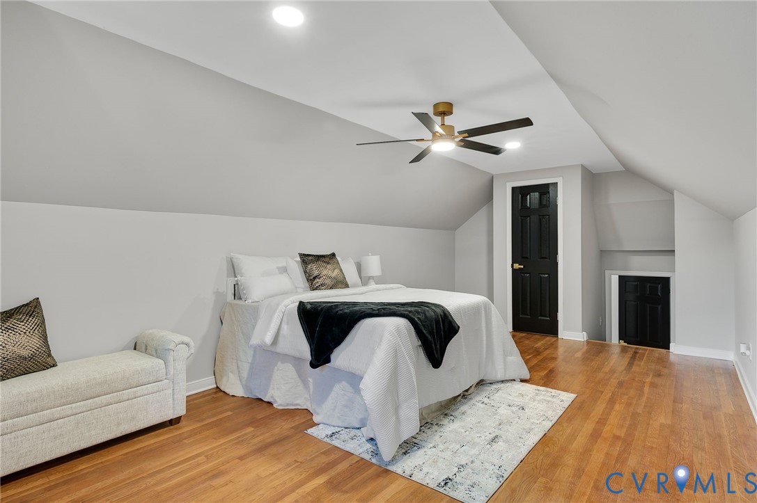 8513 Spring Hollow Drive Richmond, VA 23227 - Photo 32 of 49 a living room with a bed furniture and a fireplace