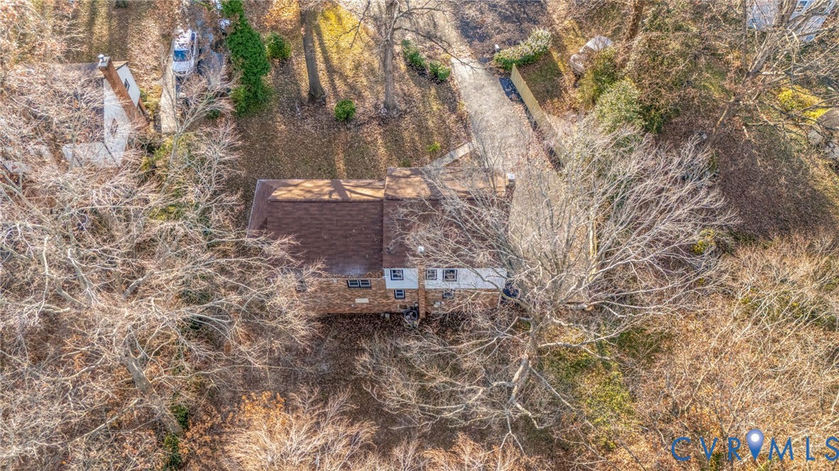 8513 Spring Hollow Drive Richmond, VA 23227 - Photo 46 of 49 a backyard of a building with large trees