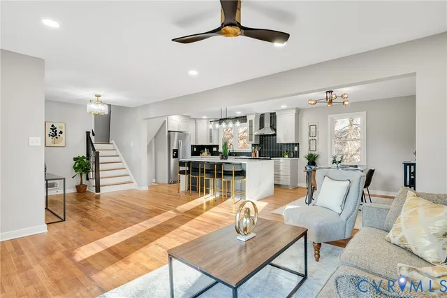 a living room with furniture and kitchen view