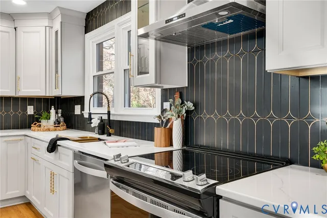 a kitchen with a sink appliances and cabinets