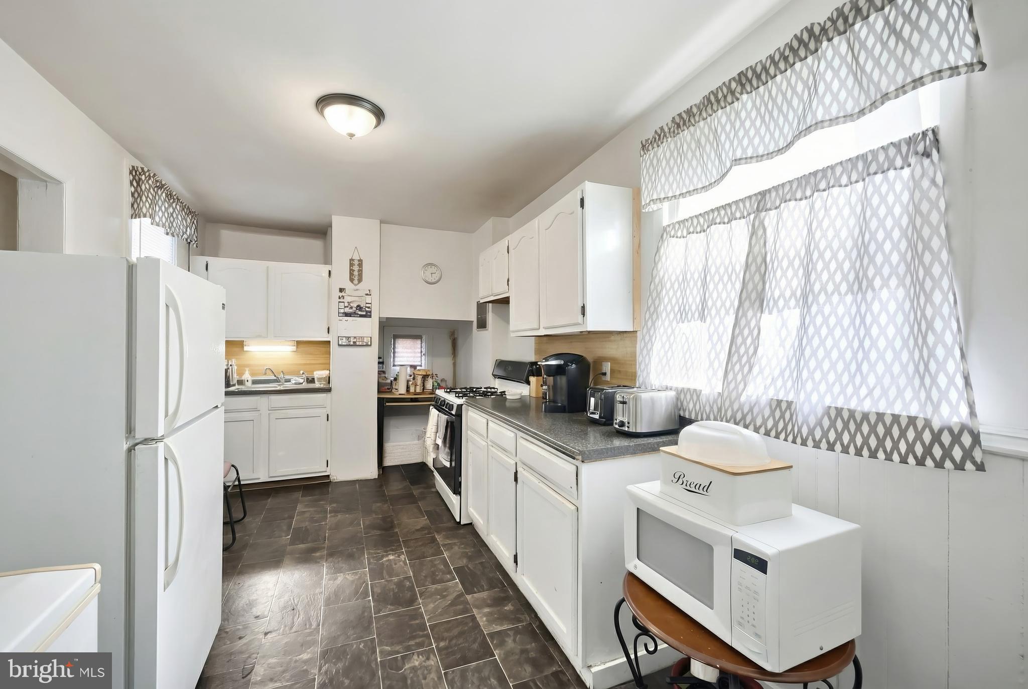 381 Simpson Street York, PA 17403 - Photo 10 of 21 a kitchen with stainless steel appliances sink stove refrigerator and cabinets