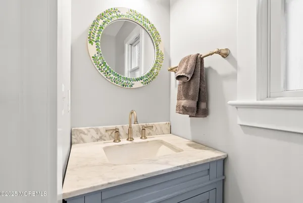 a bathroom with a table chairs and a refrigerator