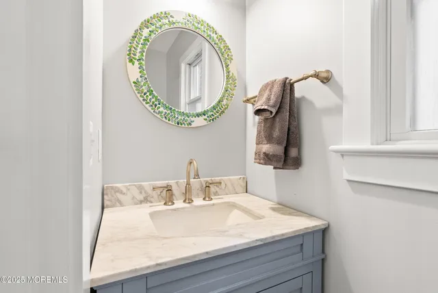 a bathroom with a table chairs and a refrigerator