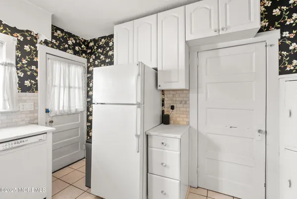 a kitchen with a stove a sink and a refrigerator