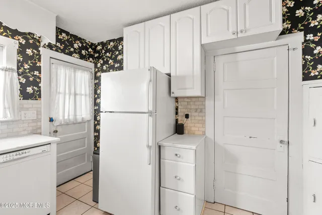 a kitchen with a stove a sink and a refrigerator