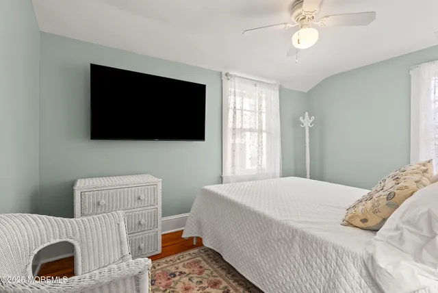 a bedroom with a bed and a mirror