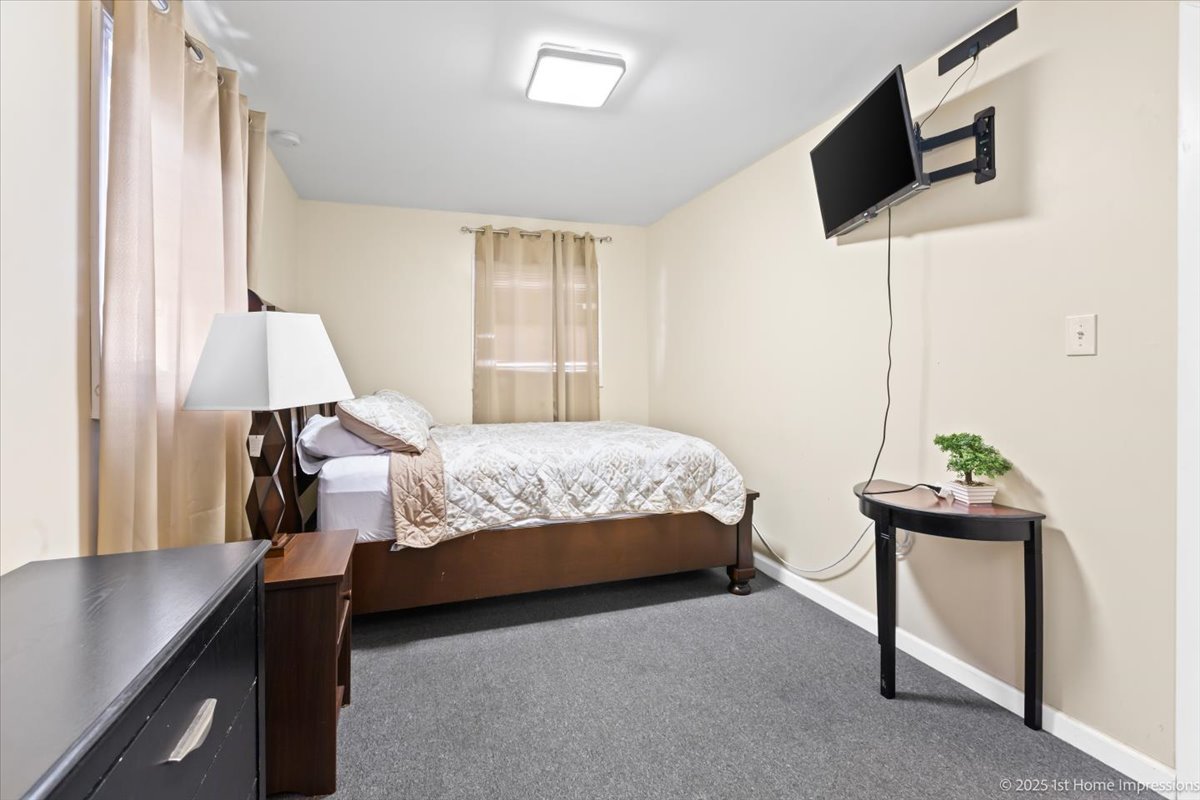 16340 Justine Street Markham, IL 60428 - Photo 10 of 19 a bedroom with a bed and a flat screen tv