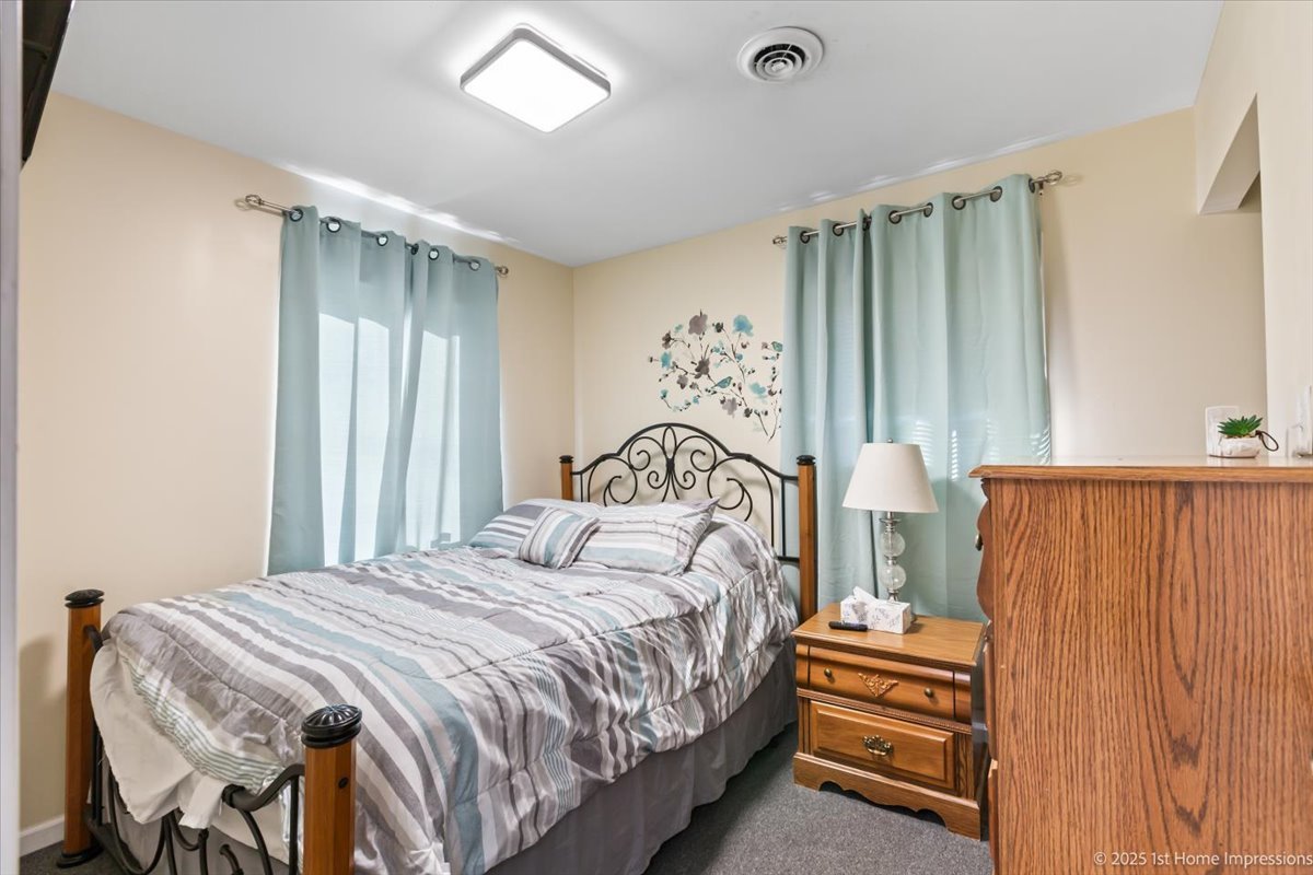 16340 Justine Street Markham, IL 60428 - Photo 11 of 19 a bedroom with a bed and a window