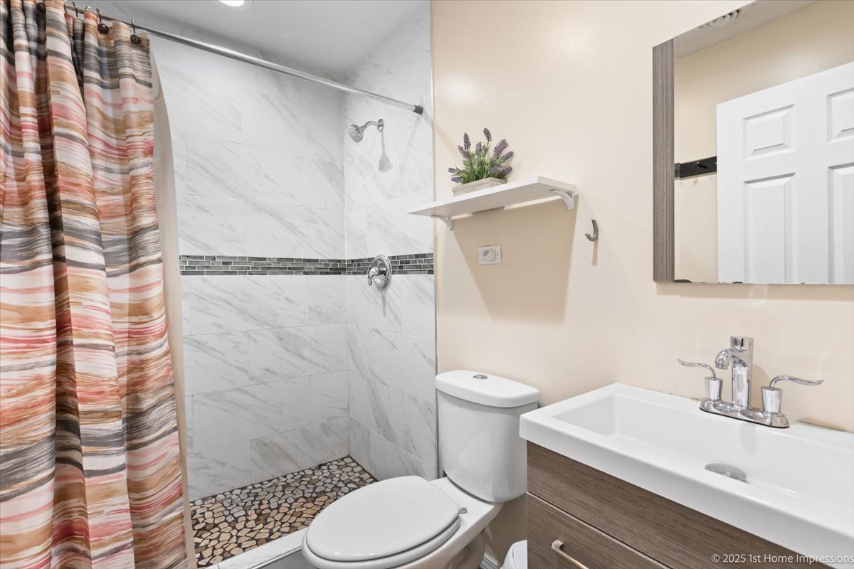 16340 Justine Street Markham, IL 60428 - Photo 13 of 19 a white toilet sitting next to a bathroom sink