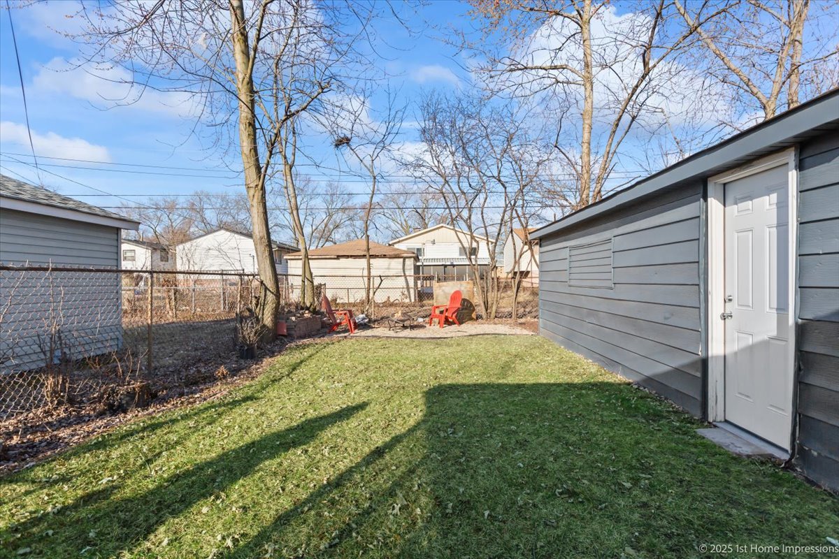 16340 Justine Street Markham, IL 60428 - Photo 19 of 19 a view of backyard with tree and wooden fence