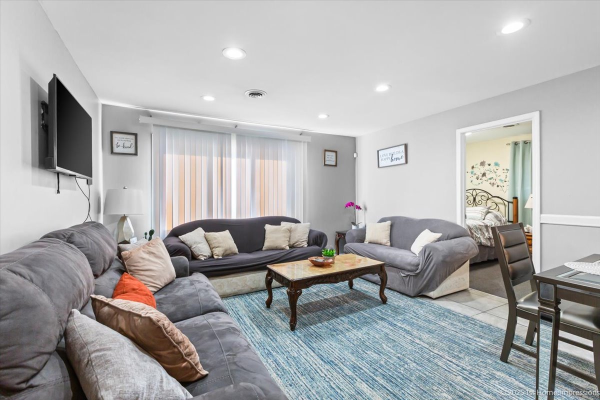 16340 Justine Street Markham, IL 60428 - Photo 2 of 19 a living room with furniture and a flat screen tv