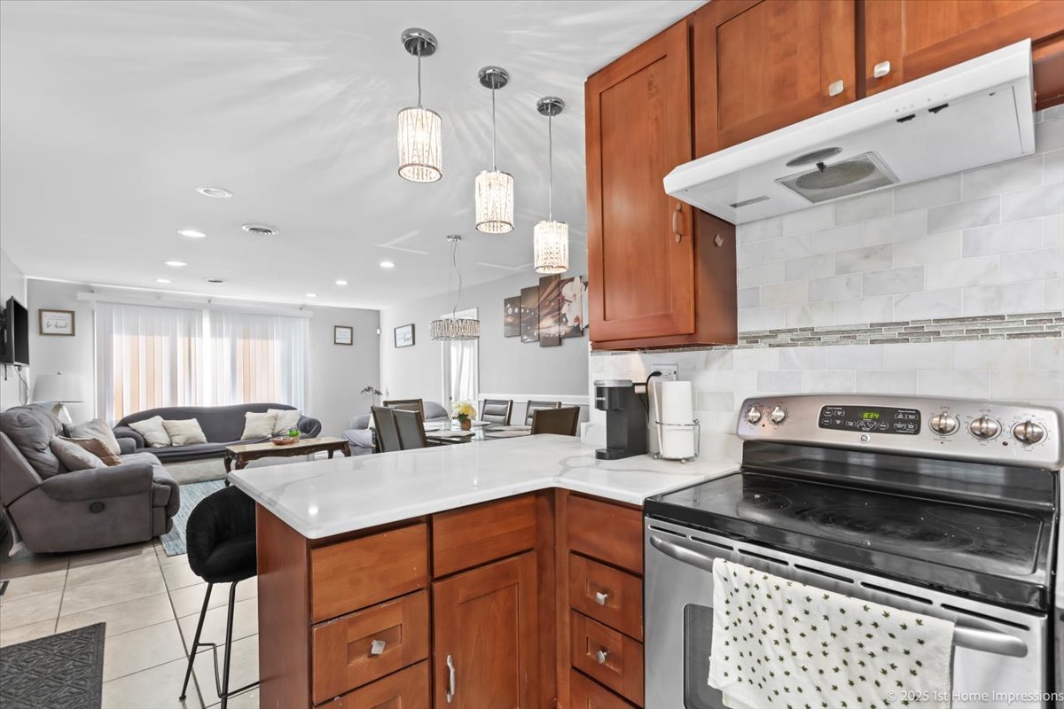 16340 Justine Street Markham, IL 60428 - Photo 7 of 19 a kitchen with a sink a stove and cabinets
