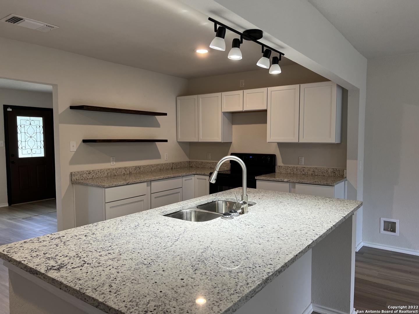 203 Murray Pleasanton, TX 78064 - Photo 1 of 1 a kitchen with a sink a stove and cabinets