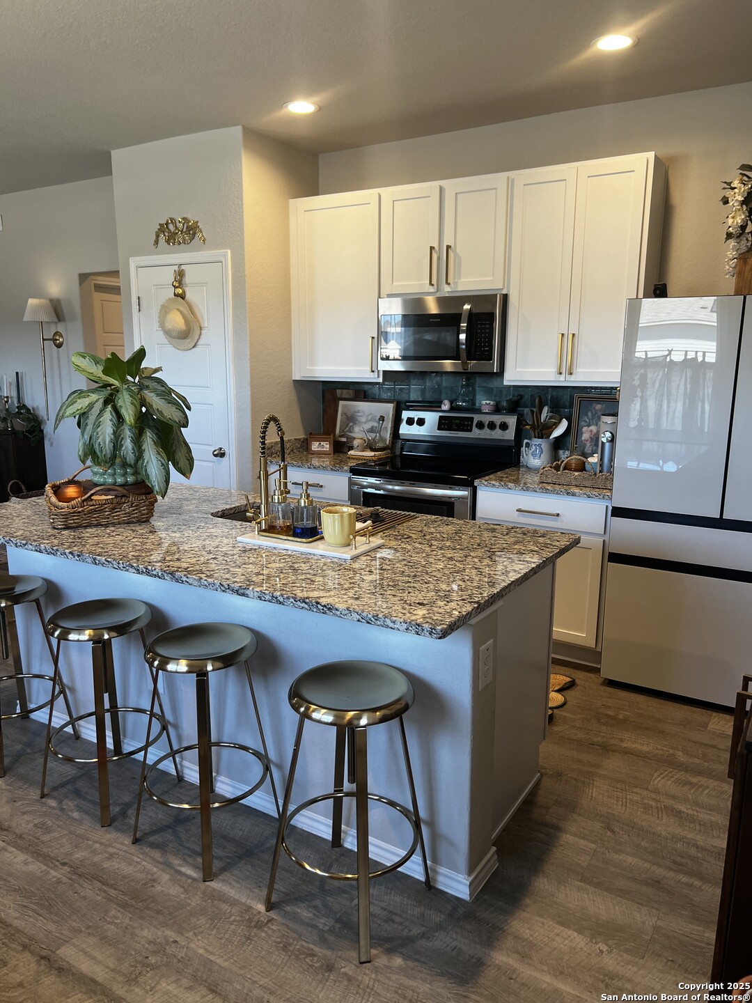 7602 Alameda Beach Converse, TX 78109 - Photo 11 of 39 a kitchen with kitchen island granite countertop wooden cabinets and counter space