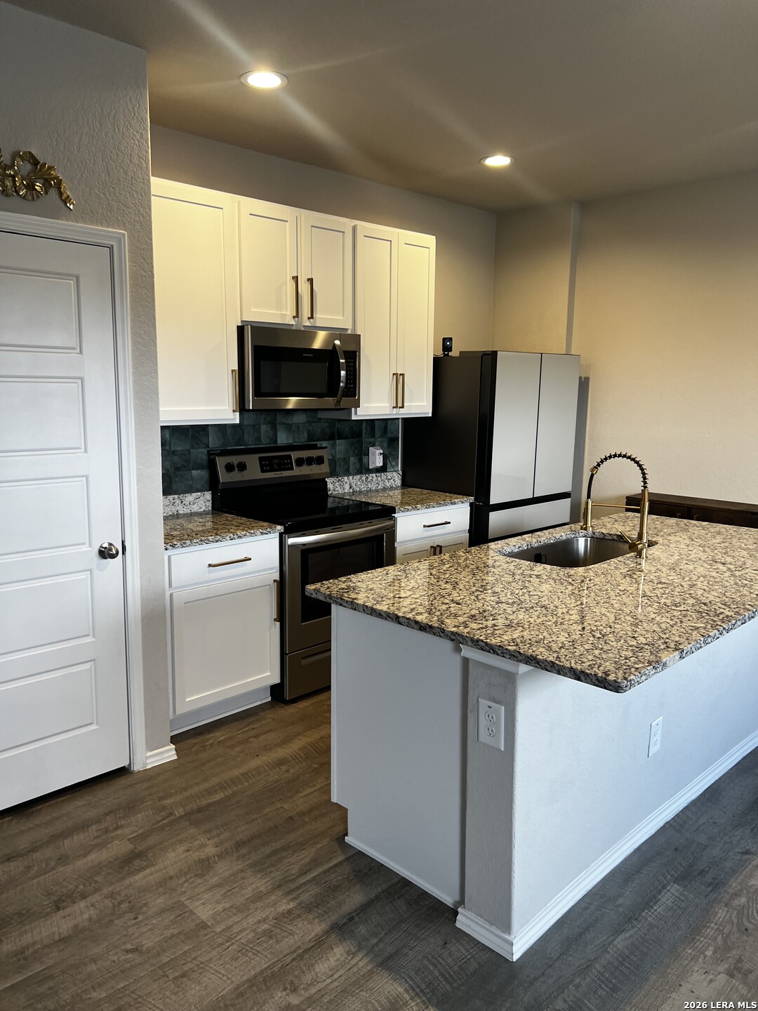 7602 Alameda Beach Converse, TX 78109 - Photo 12 of 39 a kitchen with granite countertop a sink and cabinets