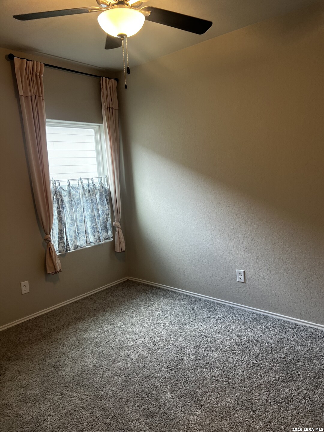 7602 Alameda Beach Converse, TX 78109 - Photo 28 of 39 en empty room with windows and chandelier fan
