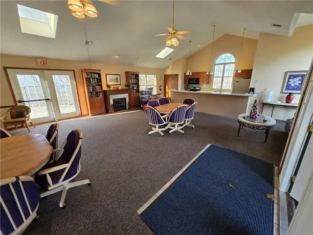 a living room with furniture a large window and a flat screen tv