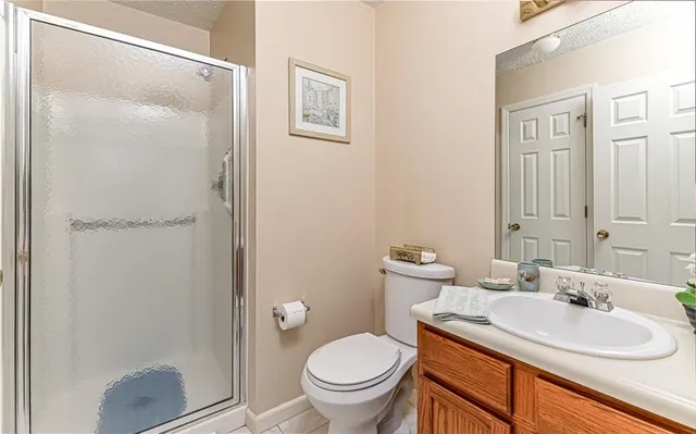 a bathroom with a sink toilet and a mirror