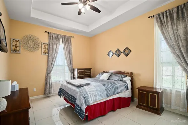 a bedroom with a bed couch and a window