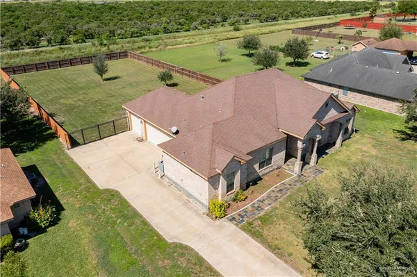 an aerial view of a house with yard swimming pool and outdoor seating