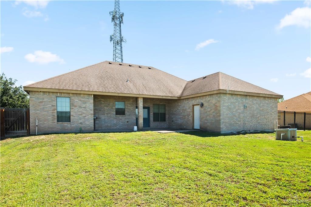 917 Beddoes Road La Feria, TX 78559 - Photo 20 of 20 a front view of a house with a yard and garage