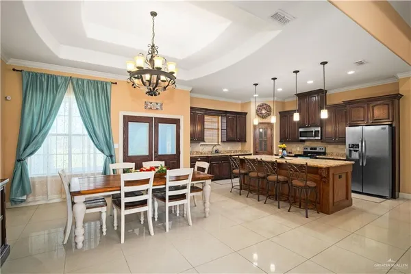 a large kitchen with a table and chairs