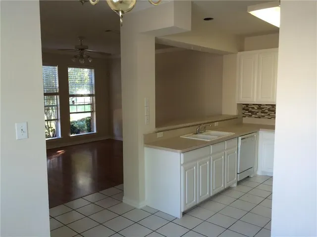 a kitchen with a stove a refrigerator and a sink