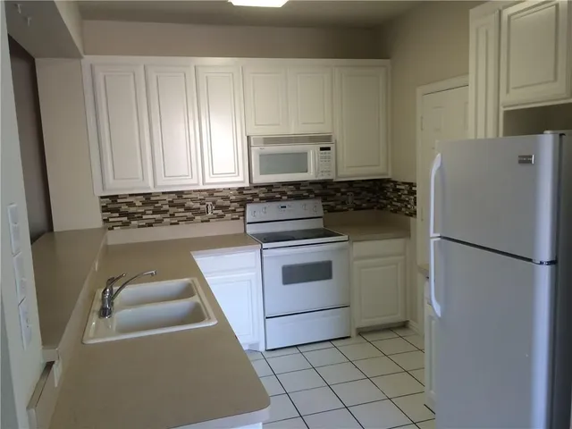 a kitchen with stainless steel appliances a refrigerator and a stove